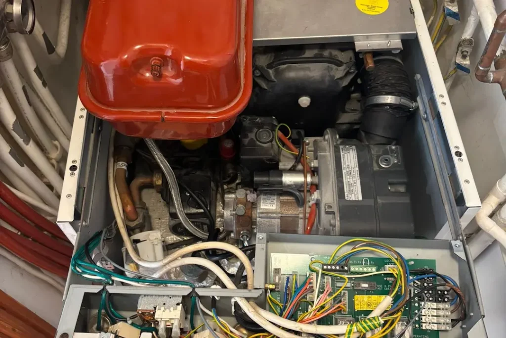 a machine with wires and a red lid